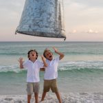 depth manipulated showing children being covered by giant bucket, while standing on Crystal Beach in Destin Florida